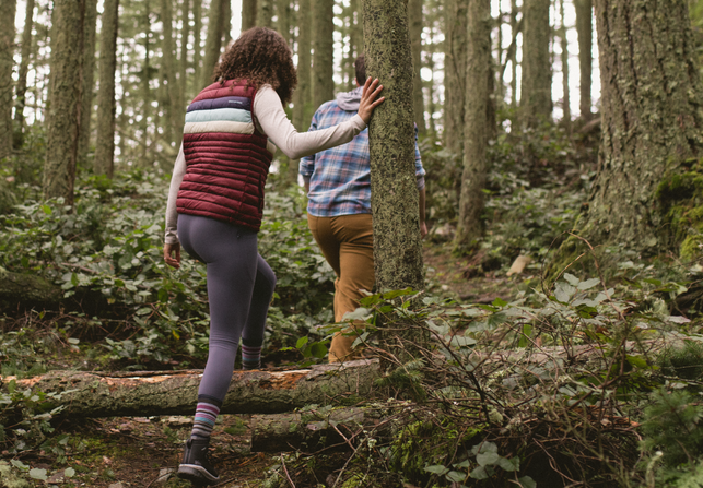 Two people adventuring through the forest