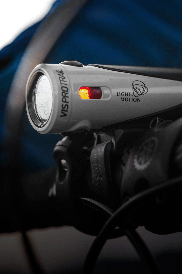 The Light & Motion Vis Pro 1000 Trail Headlight mounted on bike handlebars